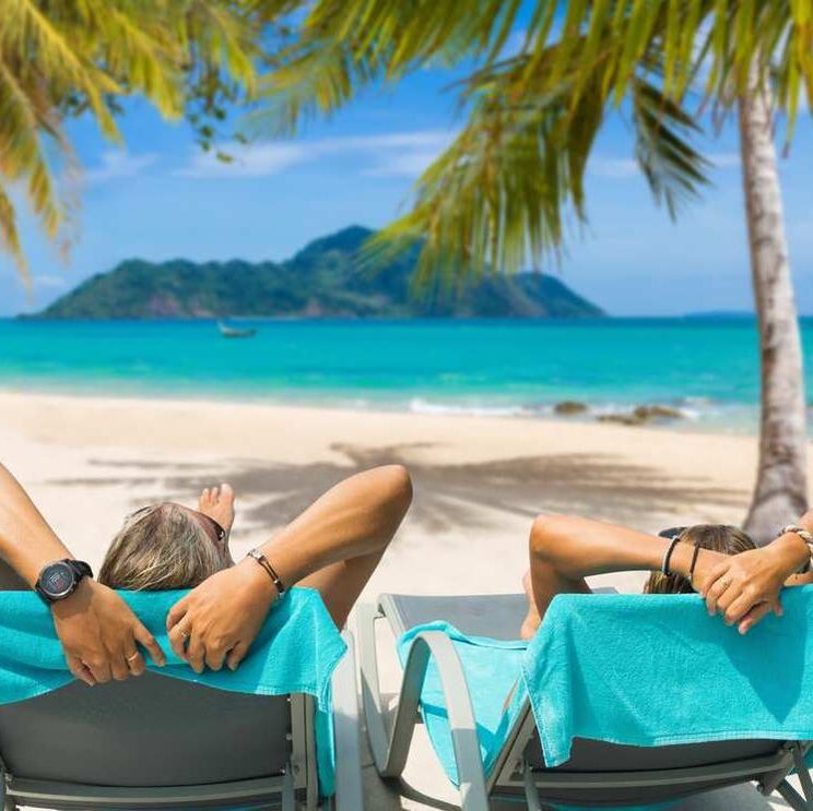 couple in beach lounges